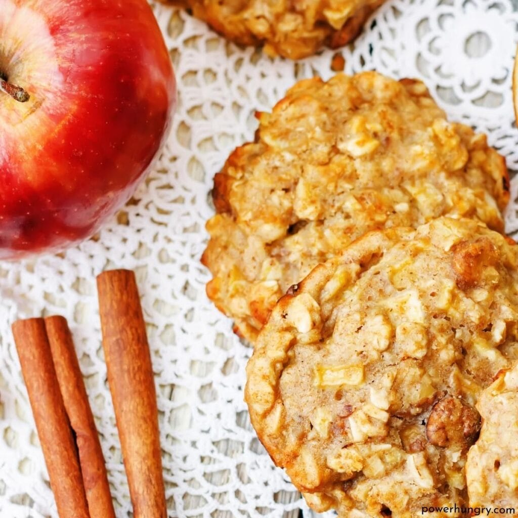 two vegan applesauce oat cookies on a lace doily