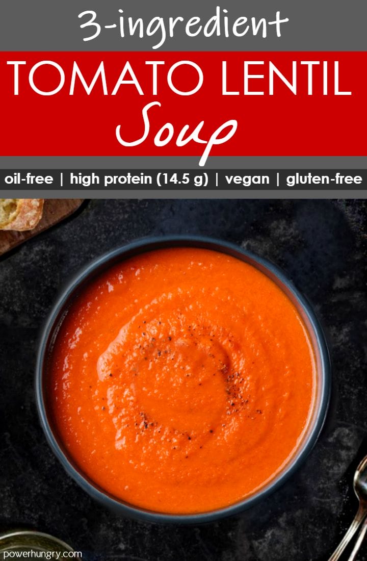 tomato and red lentil soup in a dark bowl on top of a slate board
