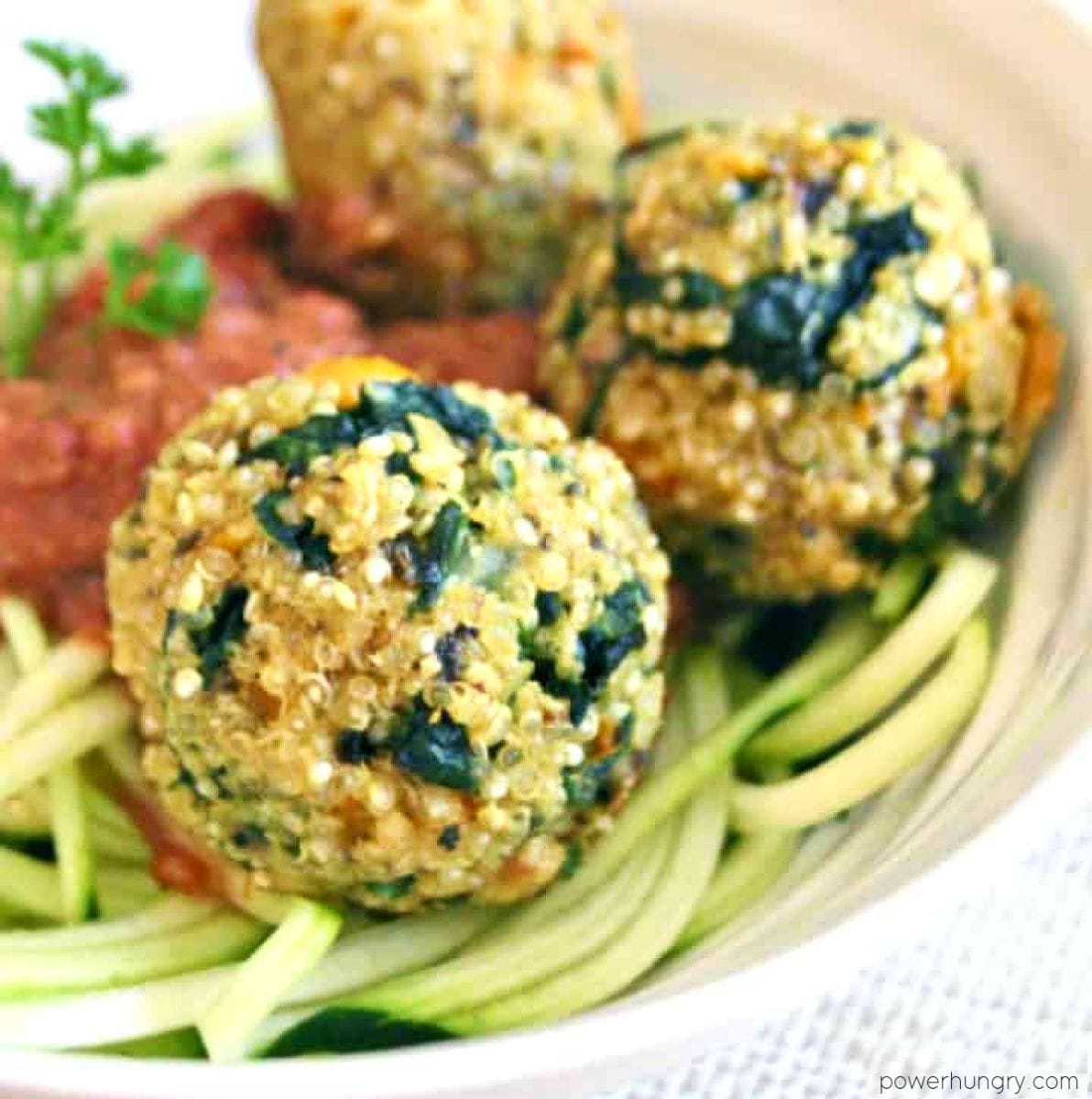 high protein quinoa kale meatballs on zucchini noodles in a white bowl