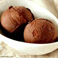 2 scoops of vegan chocolate avocado ice cream in a white dish