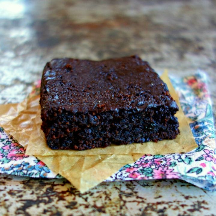 healthy vegan almond flour brownie on a parchment lined floral napkin