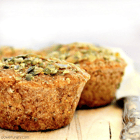 Close up of banana oat muffins, which are both vegan and gluten-free. Muffins are topped with chopped pepitas.
