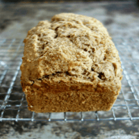 a loaf of quinoa flour and almond flour soda bread, cooling on a wire cooling rack