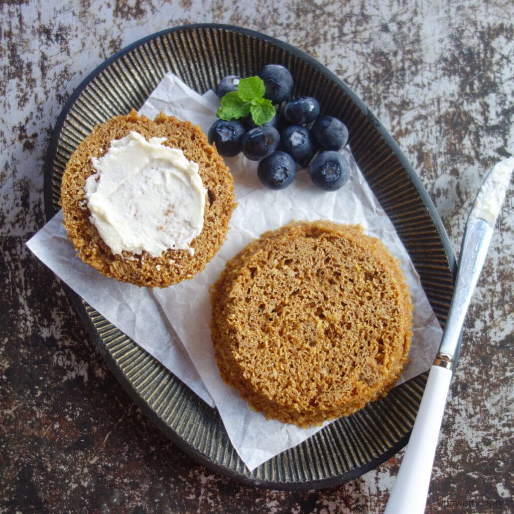 easy flax mug muffin on a metal plate, spread with nondairy butter