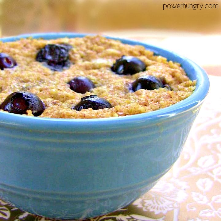 close-up of a vegan blueberry oat mug muffin in a turqoise ramekin