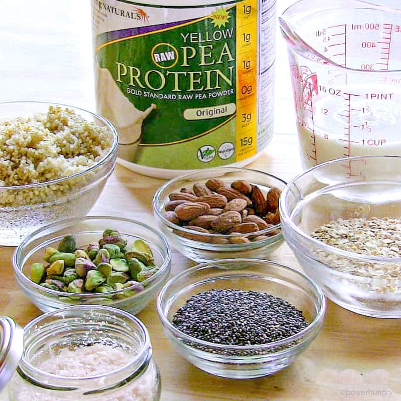 glass bowls and jars filled with the ingredients for savory vegan protein bars