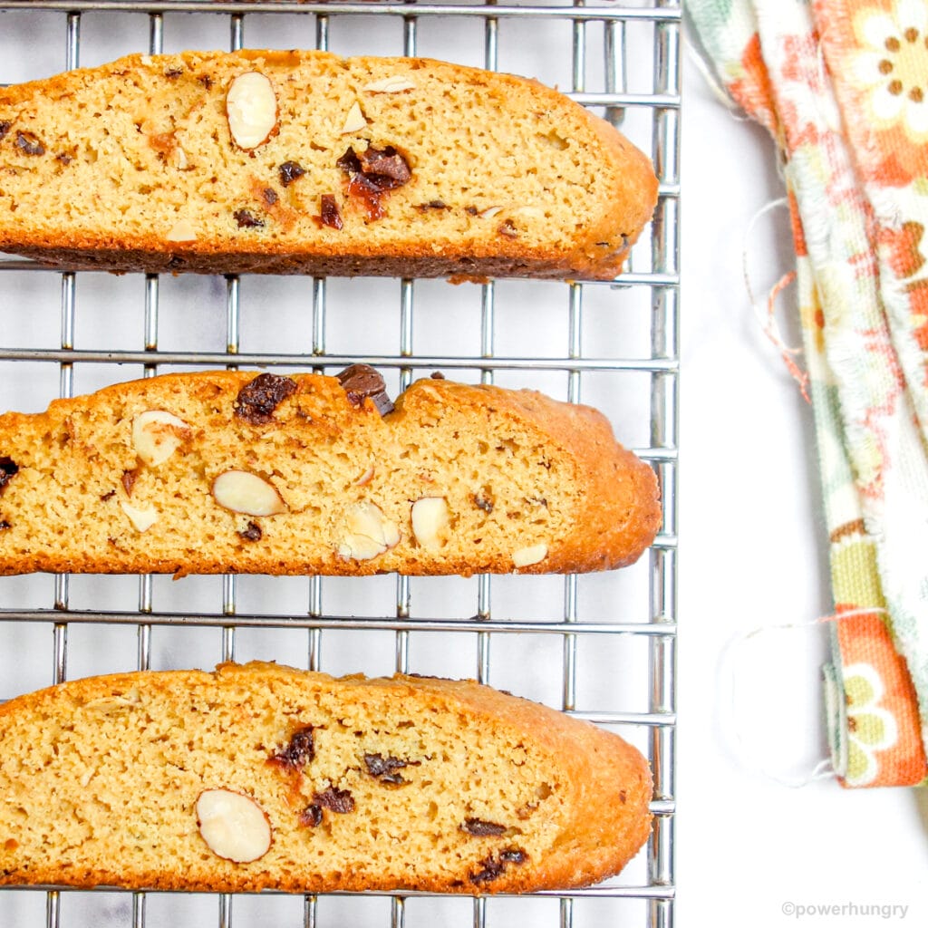 protein biscotti cooling on a cooling rack with a colorful napkin alongside