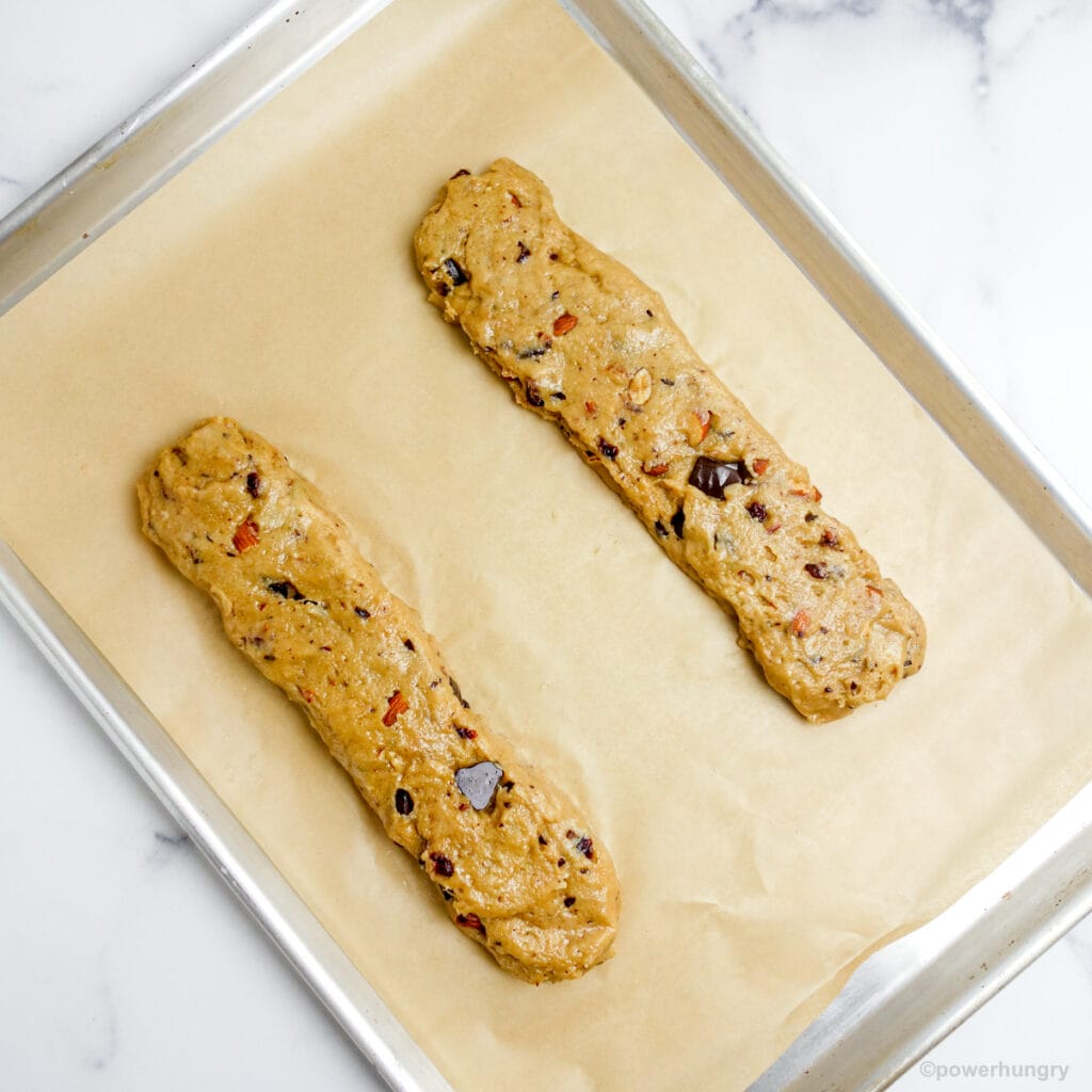 biscotti dough on a parchment lined baking sheet