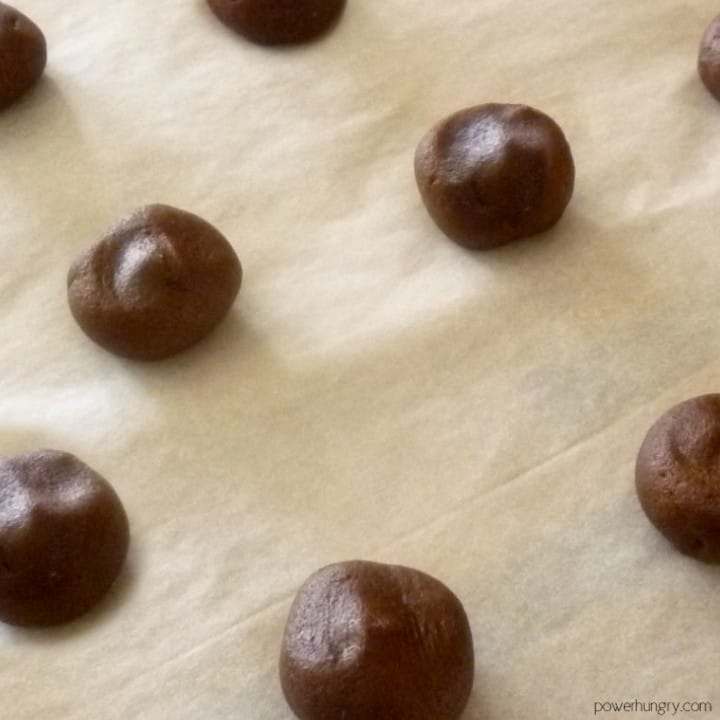 double chocolate cookie dough balls on a parchment lined baking sheet