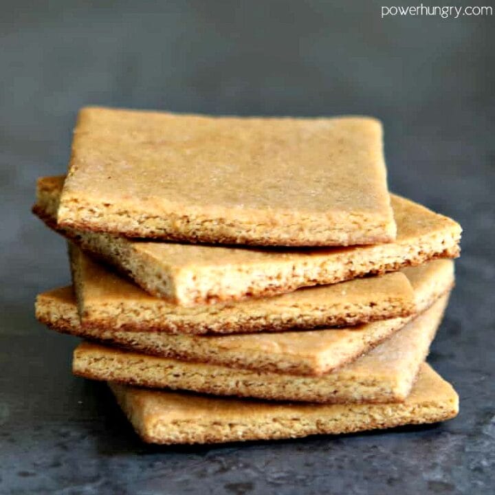 a stack of vegan almond flour graham crackers with a grey background
