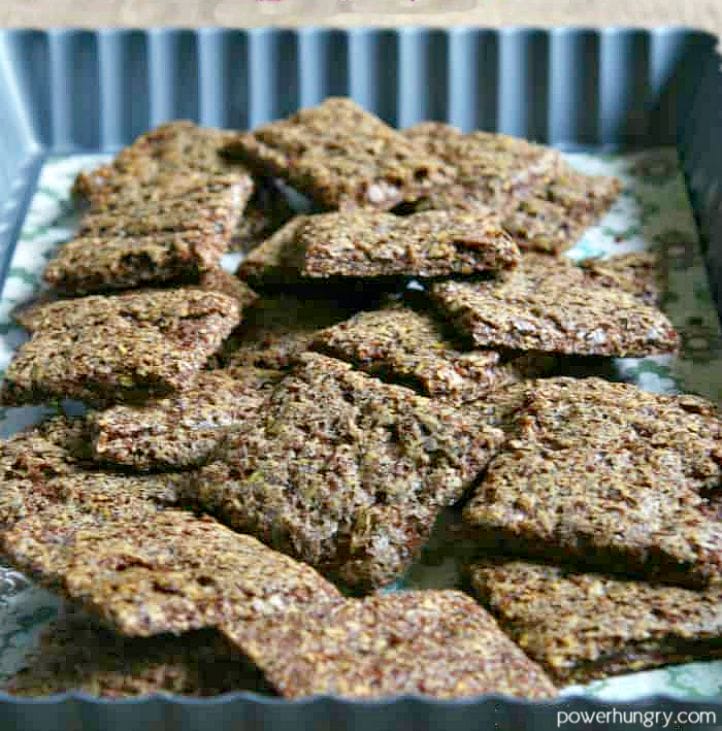 a small heap of teff crackers piled into a decorative baking dish