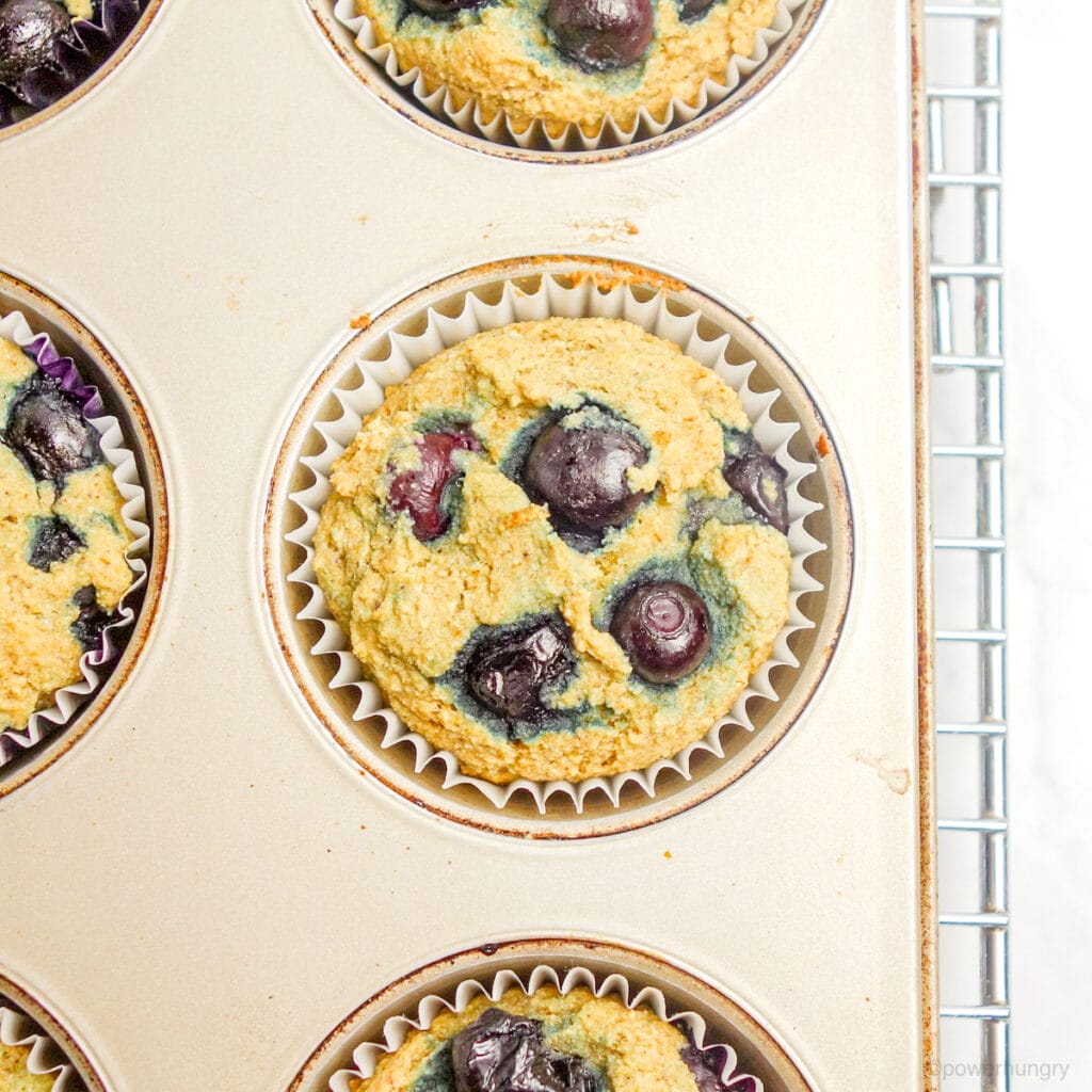 baked vegan blueberry muffins in a muffin tin