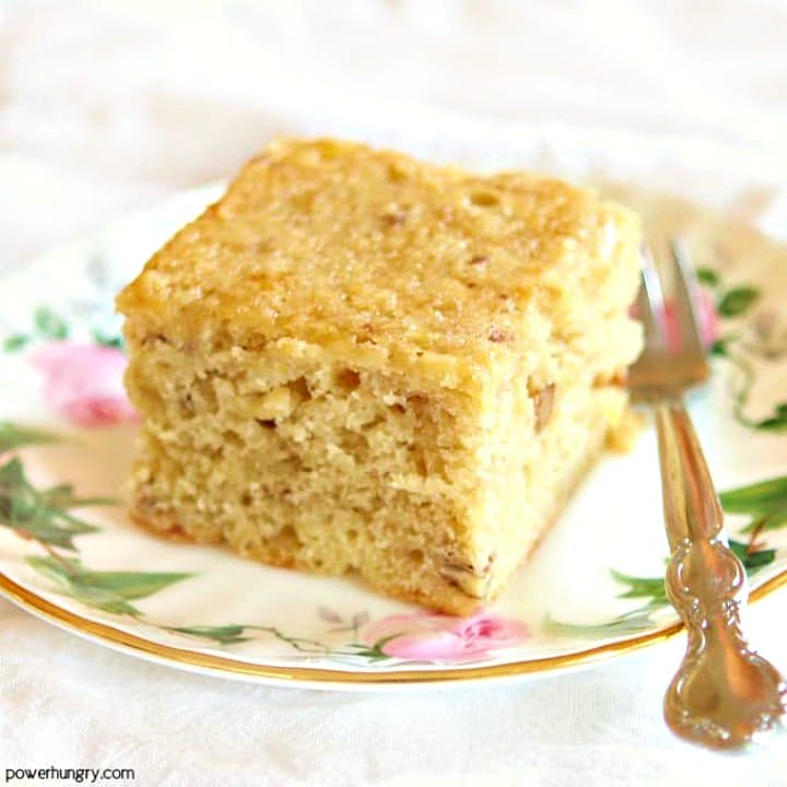 a square of vegan chickpea flour banana cake on a floral china plate