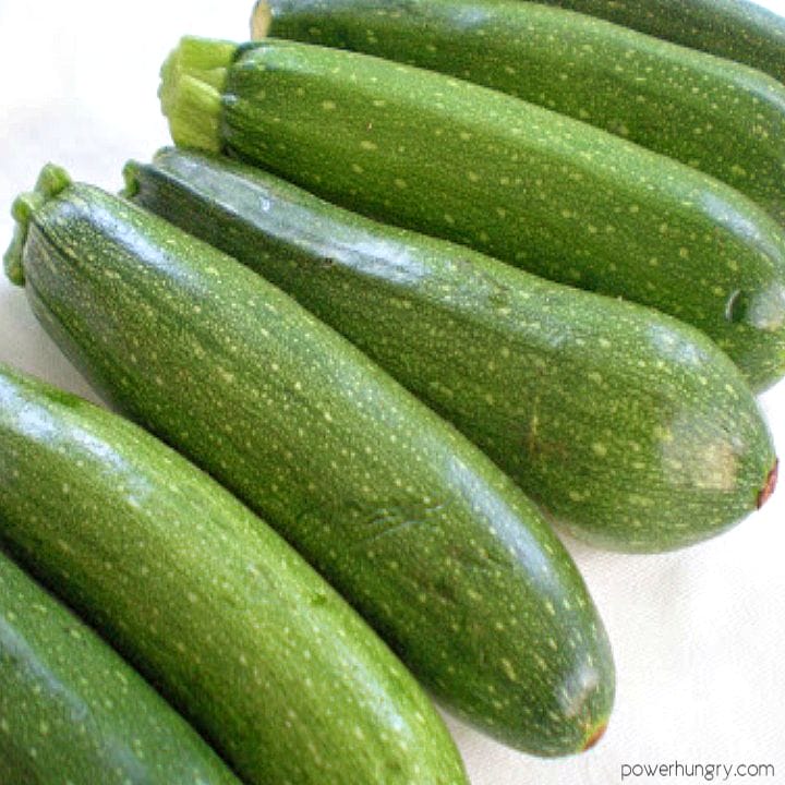 several large summer garden zucchini on a white background