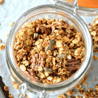 overhead shot of fresh apple pie granola in a covered glass container