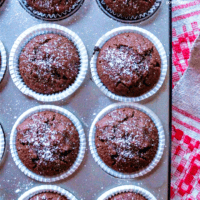 Chocolate chickpea flour muffins in a metal tin