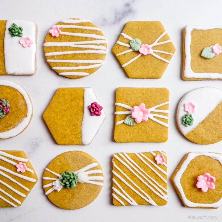 overhead shot of vegan chickpea flour sugar cookies decorated with icing