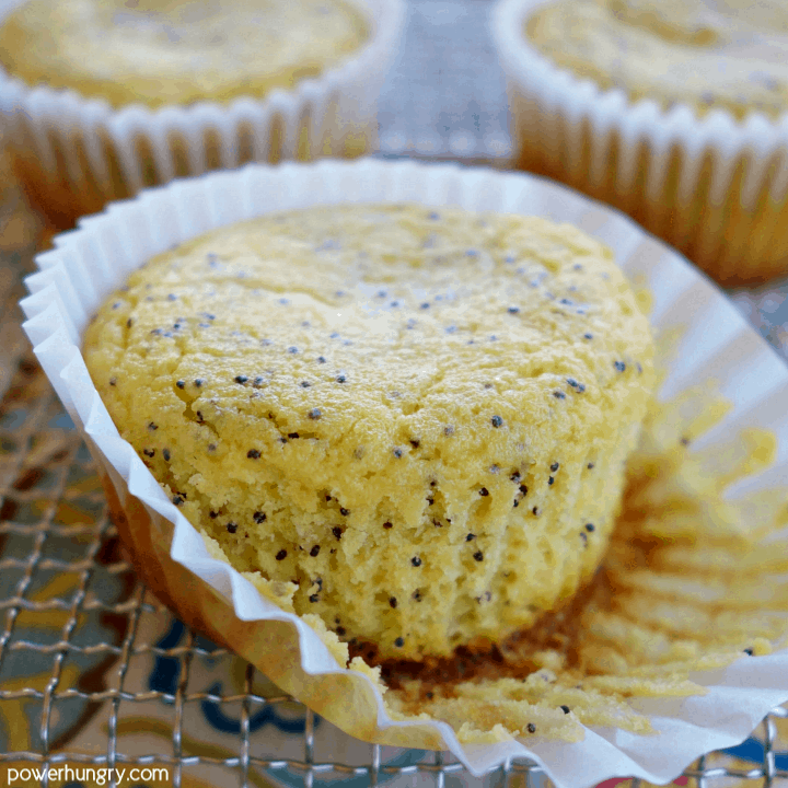 rain-free vegan lemon poppy seed muffin on a cooling rack with the paper liner peeled back