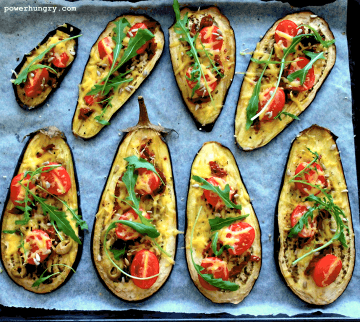 vegan eggplant pizza slices on a parchment paper lined baking sheet