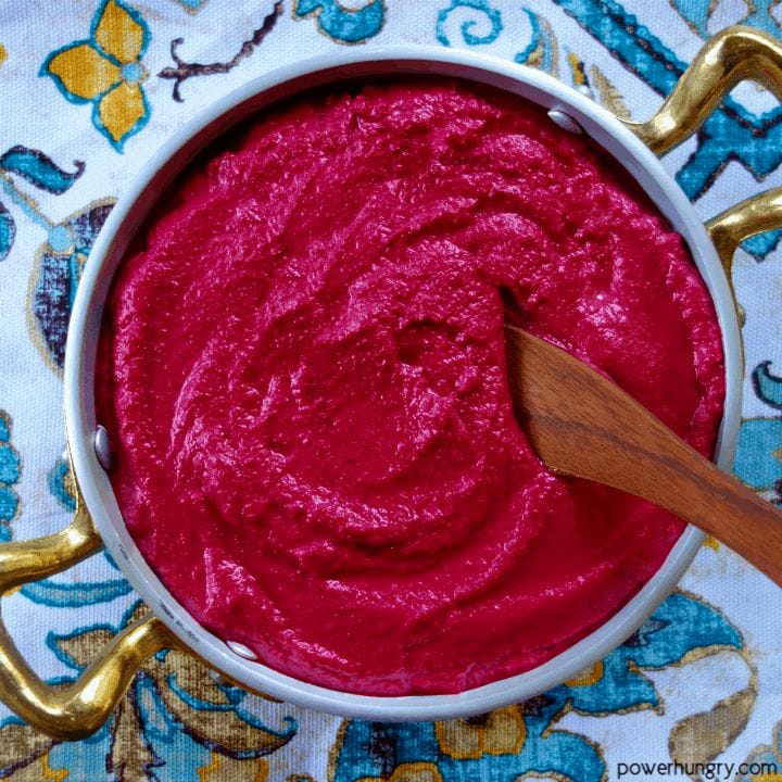 overhead shot of 4-ingredient beet hummus n a silver and gold bowl