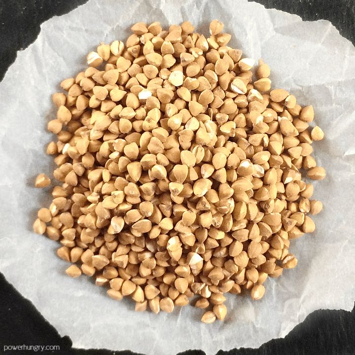 pile of buckwheat groats on a piece of white parchment paper
