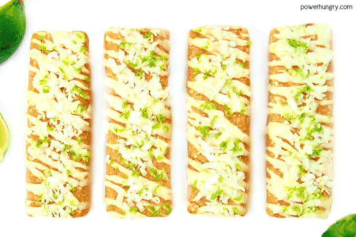 coconut lime protein bars on a white plate with some limes