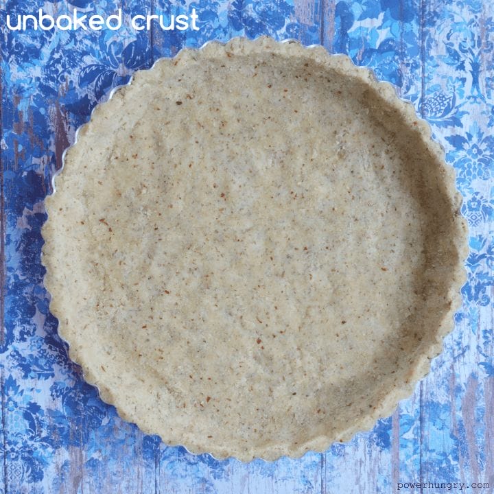 unbaked coconut flour-almond flour pie crust on a blue background