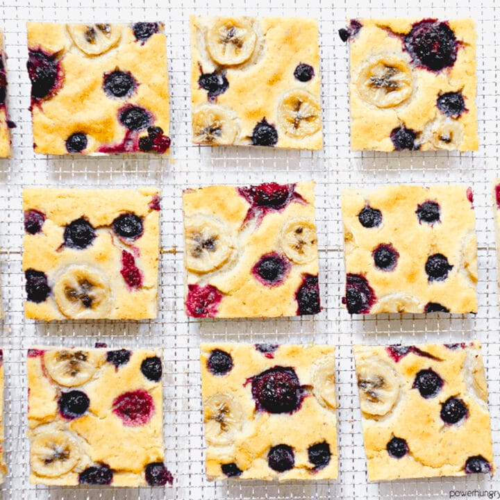squares of vegan baked pancake with berries on a cooling rack