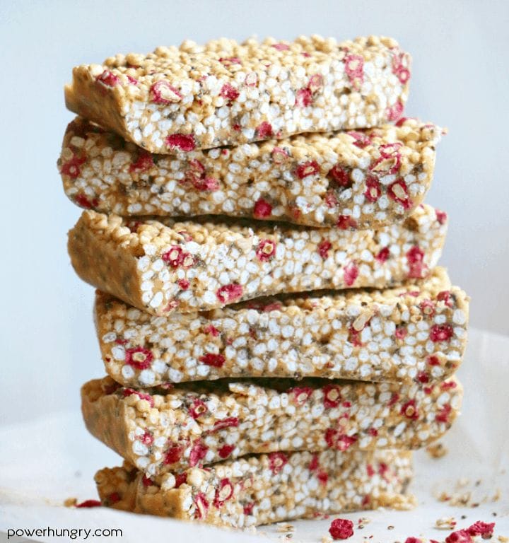 lemon & strawberry puffed millet bars stacked on a piece of white parchment paper
