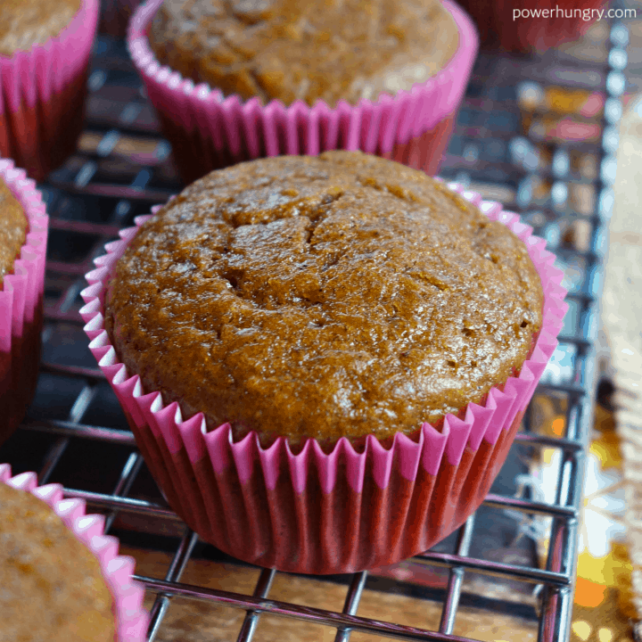 close up of a vegan chickpea flour gingerbread muffin on a cooling rack