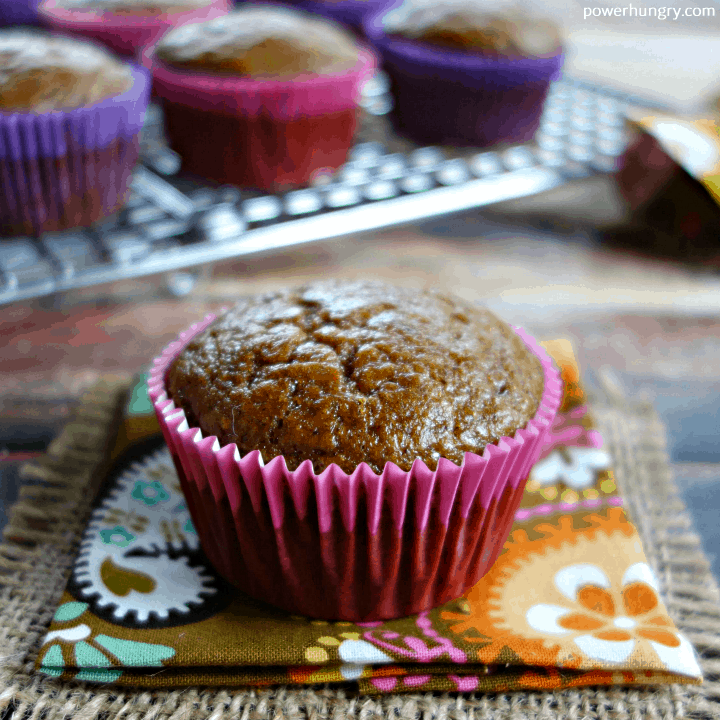 gingerbread chickpea flour muffin on a colorful fall napking, with more muffins in the background