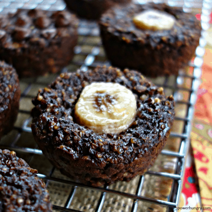 4-ingredient chocolate quinoa muffins on a silver cooling rack with a colorful napking alongside