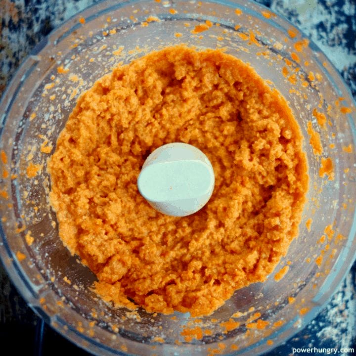 overhead shot of food processor bowl filed with carrot puree 