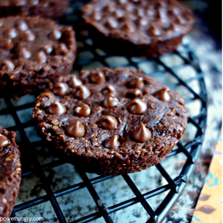 close-up of a double-chocolate 100% flax breakfast cookie on a round, black metal cooling rack