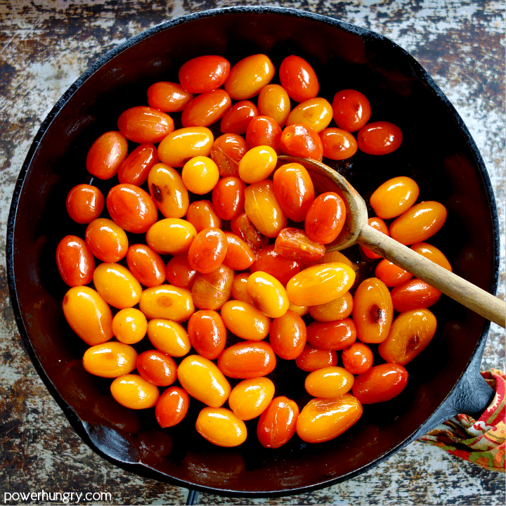 Skillet of sauteed cherry tomatoes in olive oil