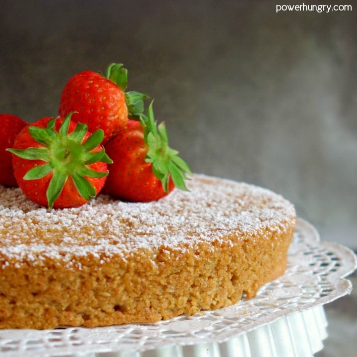Vegan almond flour cake with strawberries on cake stand