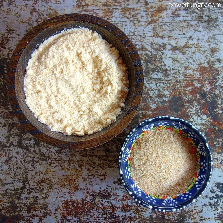 2 small decorative bowls, one filled with coconut flour, the other, psyllium husk