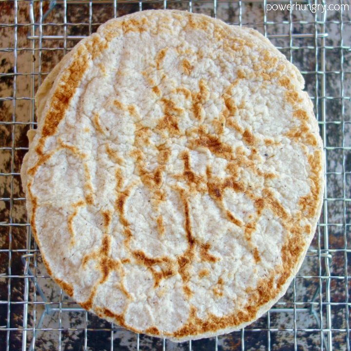 puffed 2-ingredient coconut flour tortilla cooling on a metal cooling rack