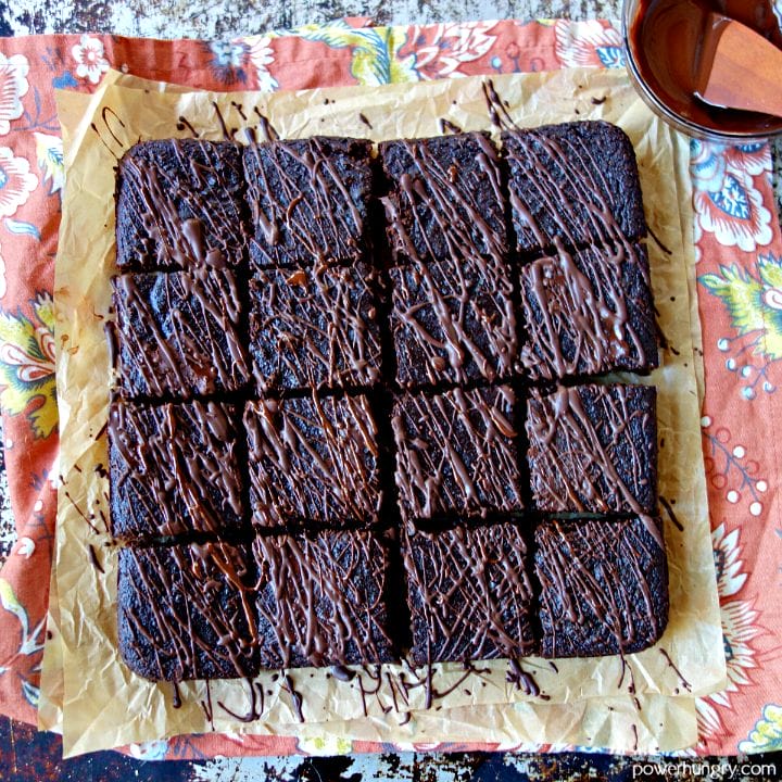 fudgy vegan brownies, cut into squares, and drizzled with dark chocolate