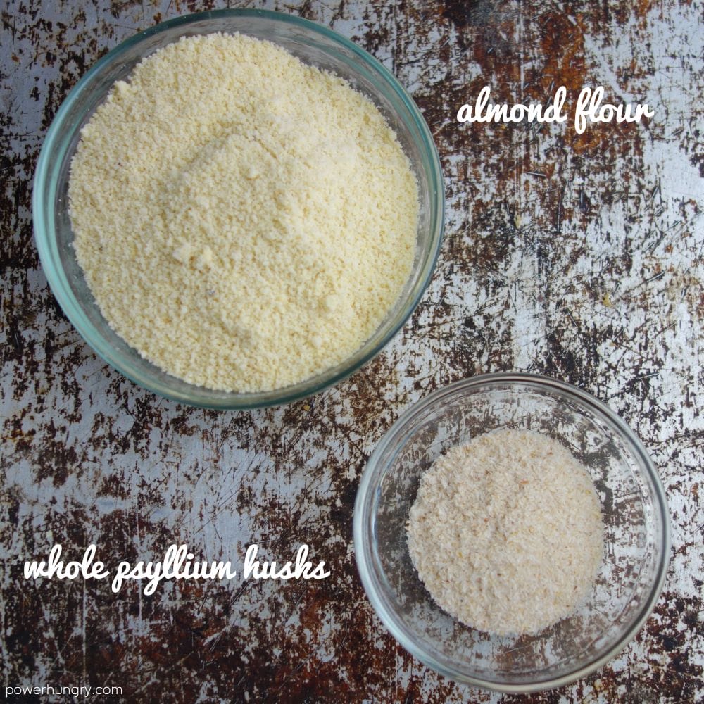 2 glass bowls, one filled with almond flour, one filled with whole psyllium husks