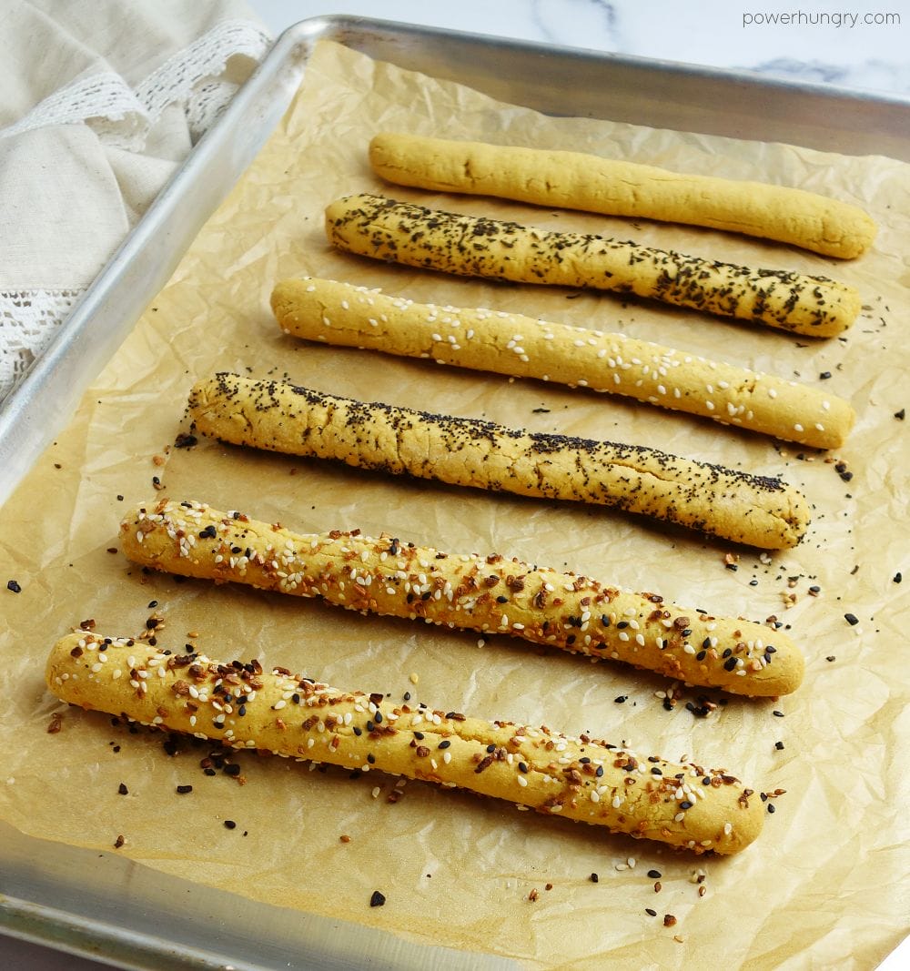 parchment paper-lined baking sheet with baked breadsticks on top