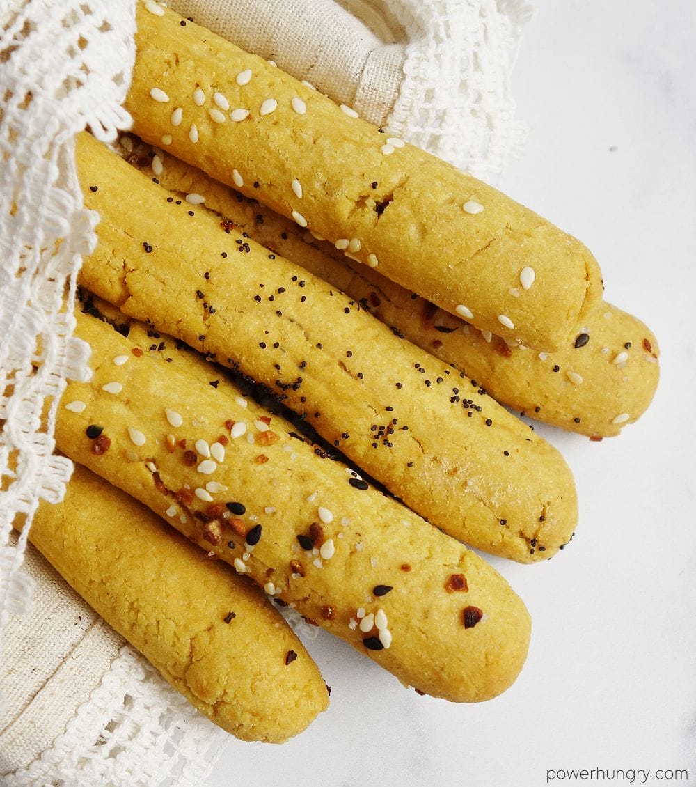 a batch of chickpea flour breadsticks wrapped in a lace-edged napkin