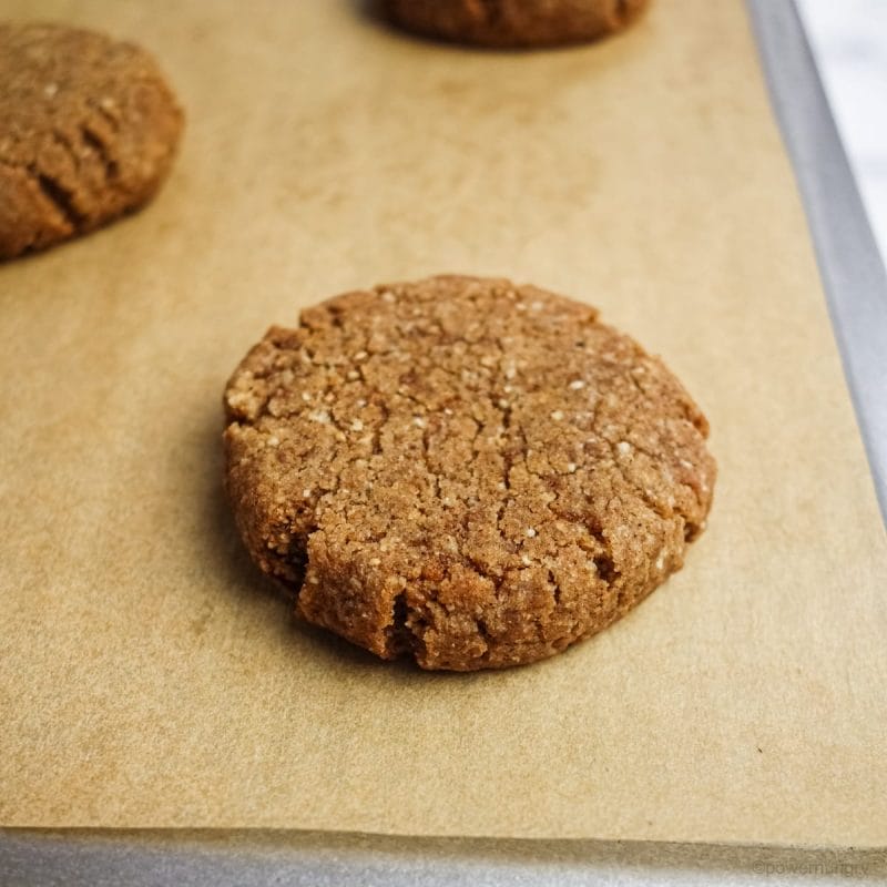 ginger cookie on a parchment paper lined cookie sheet