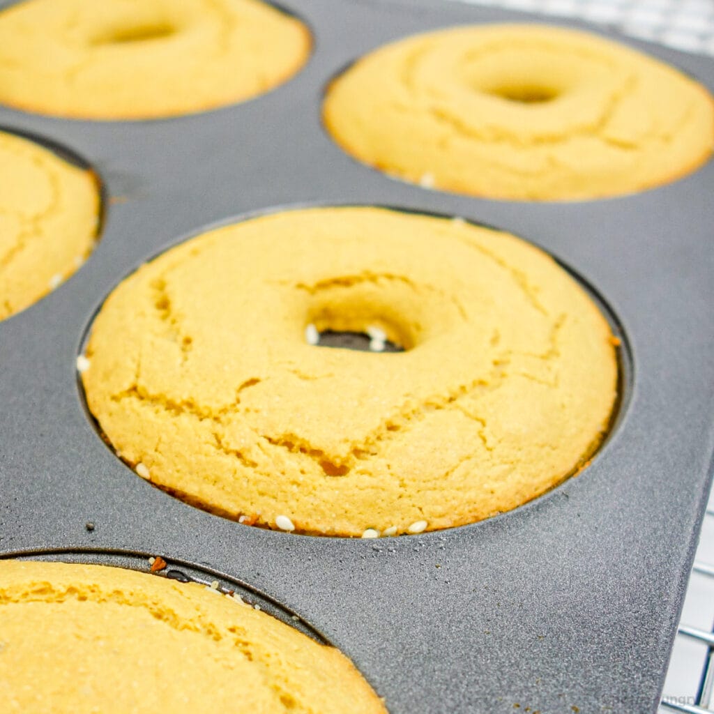 vegan chickpea flour bagels, fresh out of the oven in a donut pan