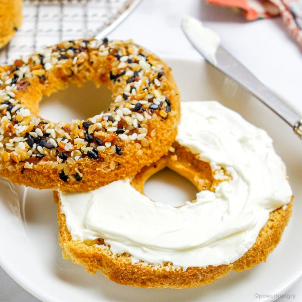 sliced chickpea flour bagels with cashew cream cheese spread on it