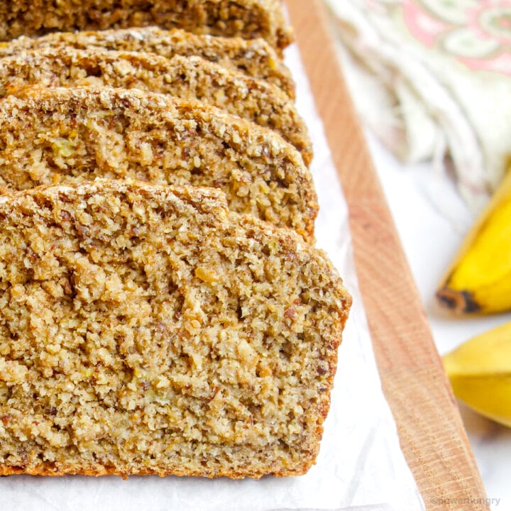 close up of slices of vegan oat flour banana bread, sliced, on a cutting board