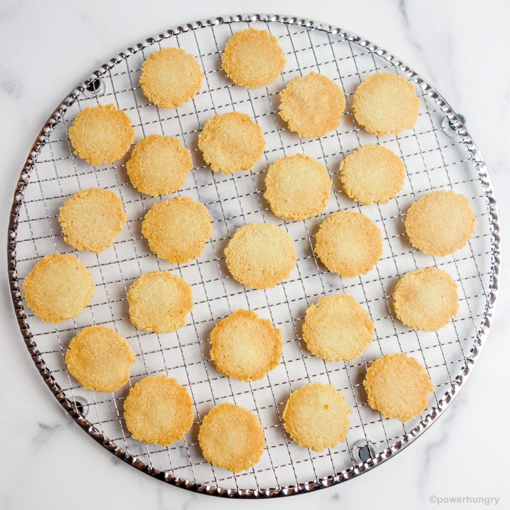 overhead shot of a silver cooling rack covered in almond flour crackers