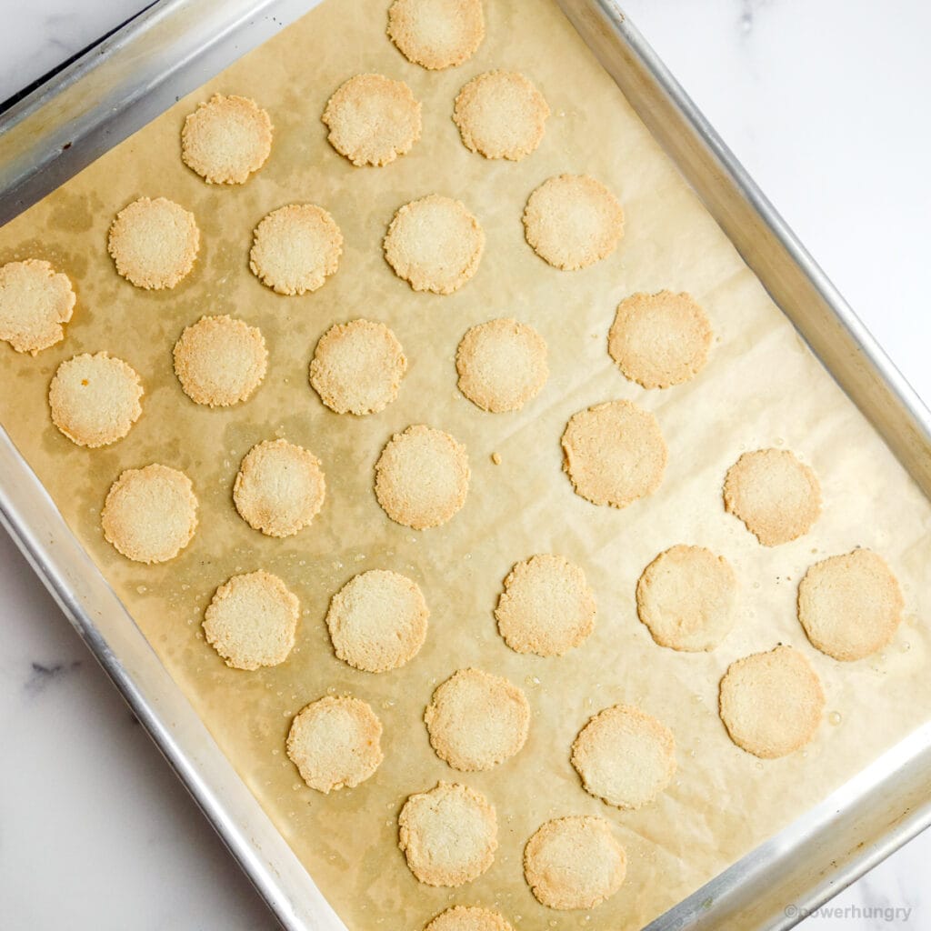 freshly baked almond flour crackers on a parchment lined baking sheet