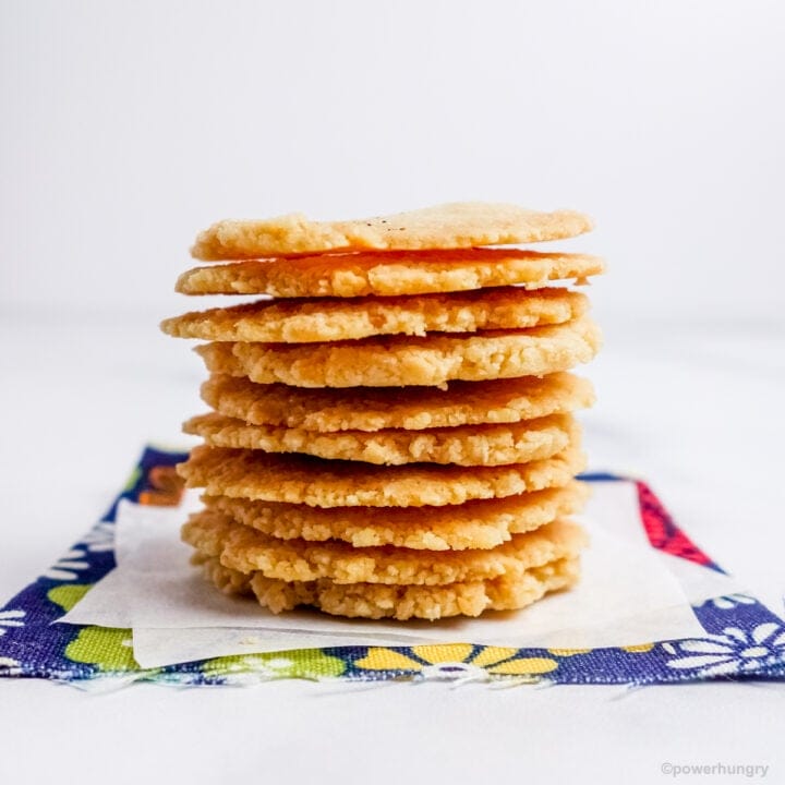 a stack of almond flour crackers on a blue floral napkin