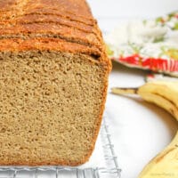 close up of a loaf of millet banana bread on a cooling rack